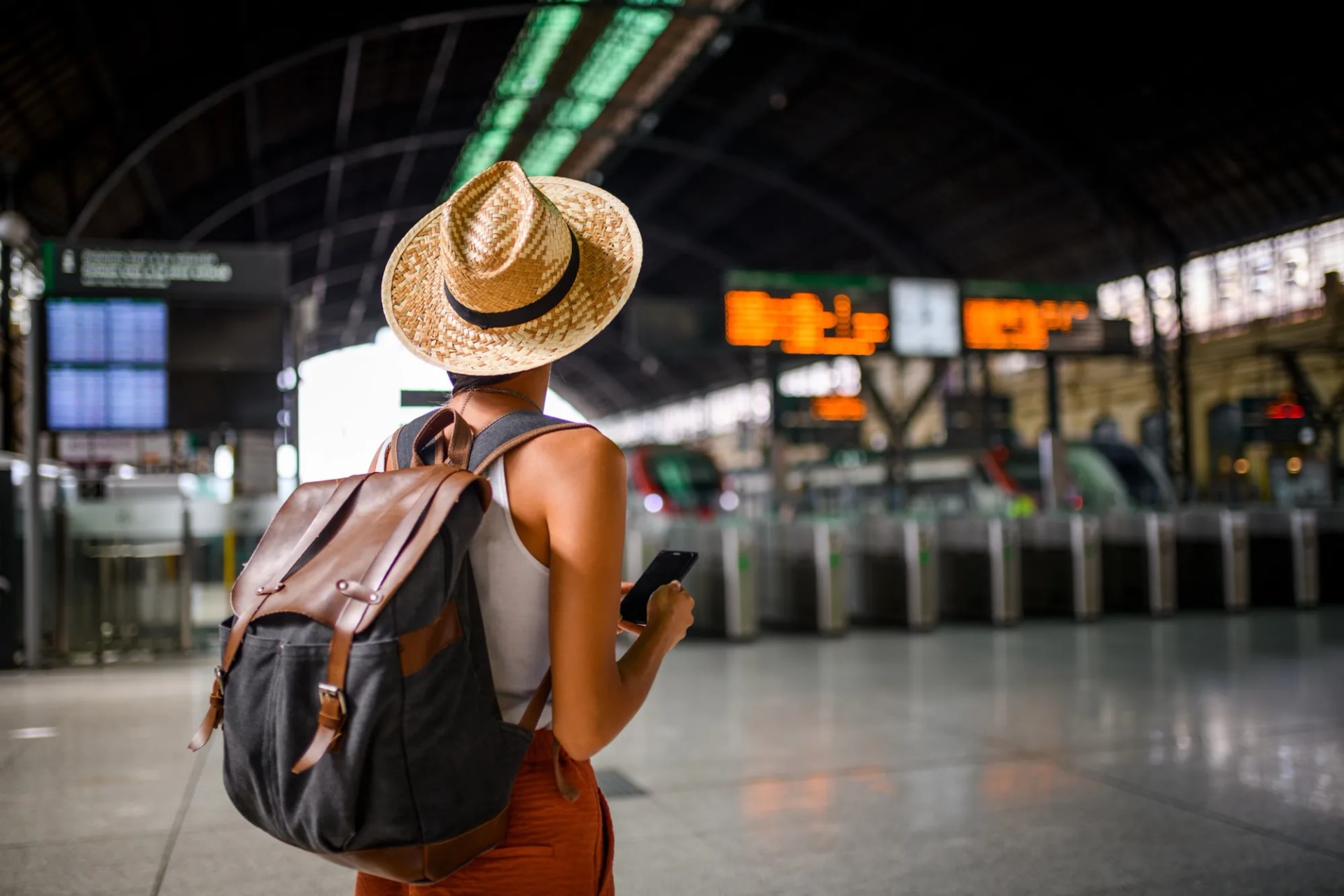 Traveler checking phone at a train station